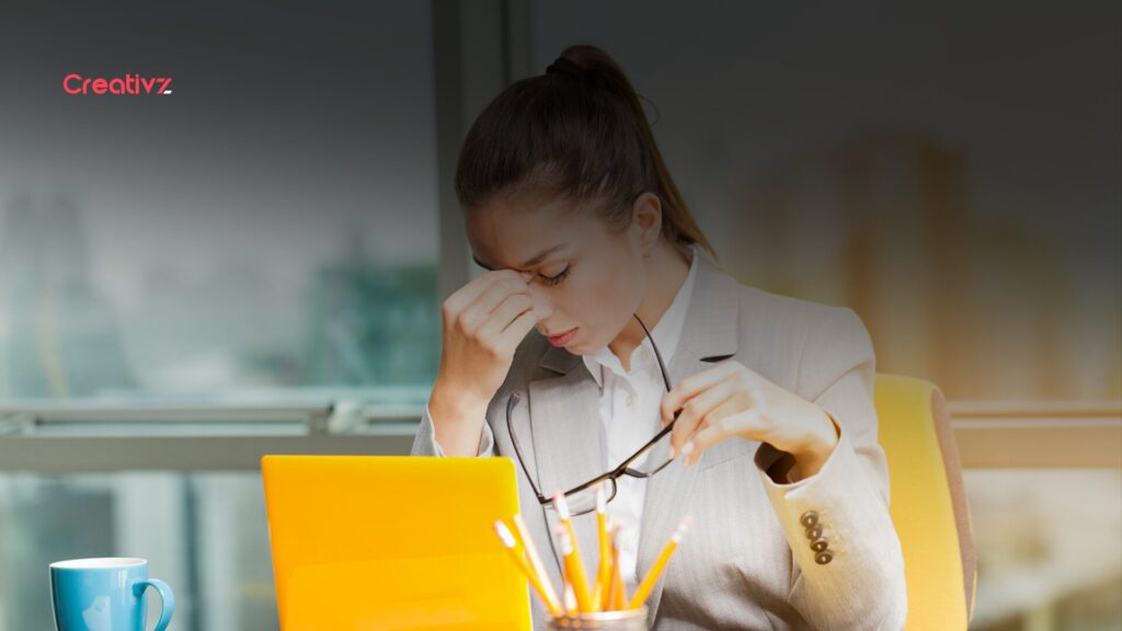 New hire sitting at an empty desk looking uncertain on their first day at a growing company