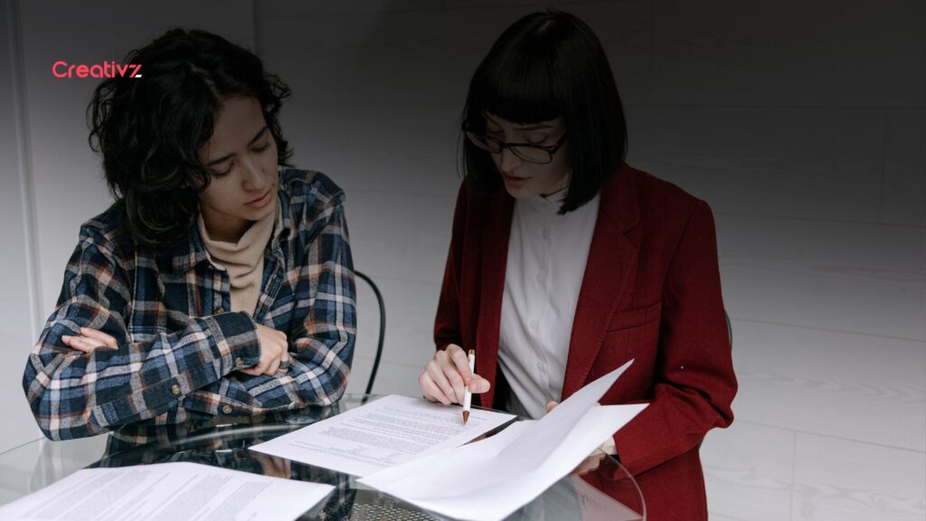 Two B2B professionals reviewing sales data during a negotiation meeting