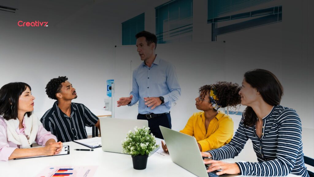 Manager leading a structured onboarding session with a small team in a modern office setting