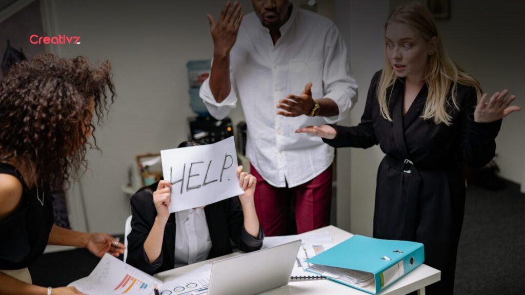 Stressed employee signaling for help as team reacts, representing inefficient processes and stalled operations without autonomous workflows