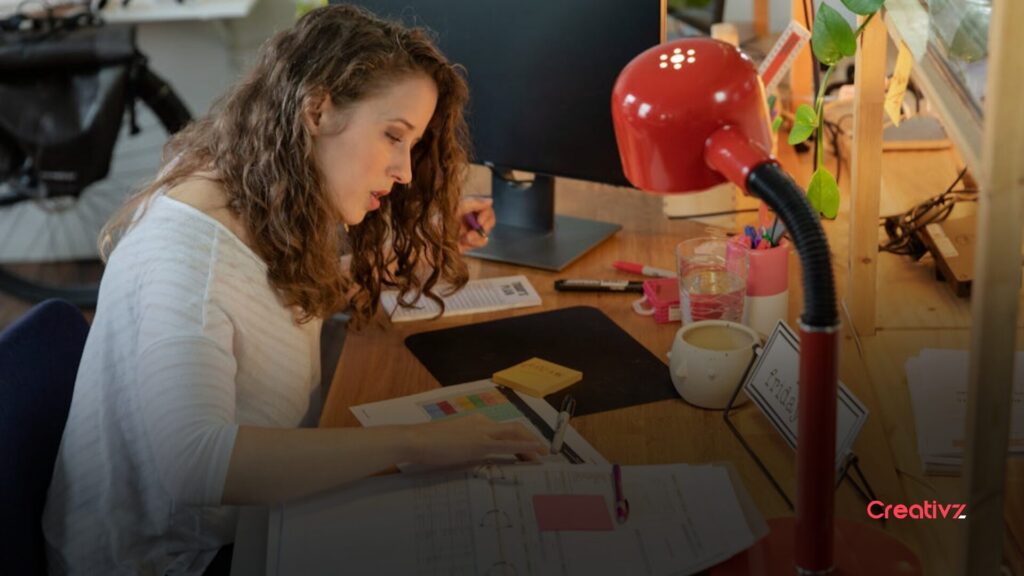 Founder reviewing documents and data at a desk, looking focused but uncertain about marketing performance and results.