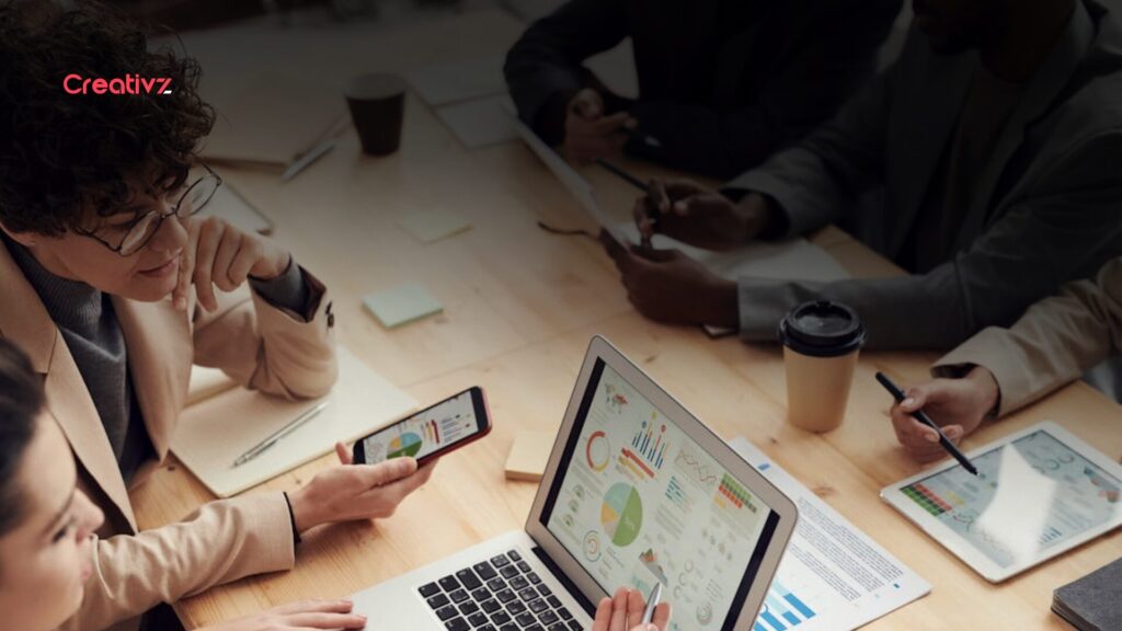 Business leadership team reviewing delayed analytics and reporting dashboards during a strategy meeting, representing the operational cost of slow business decision-making systems.