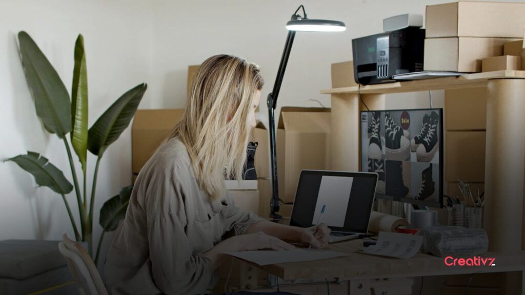 Business owner documenting processes and reviewing notes to build a structured sales system.