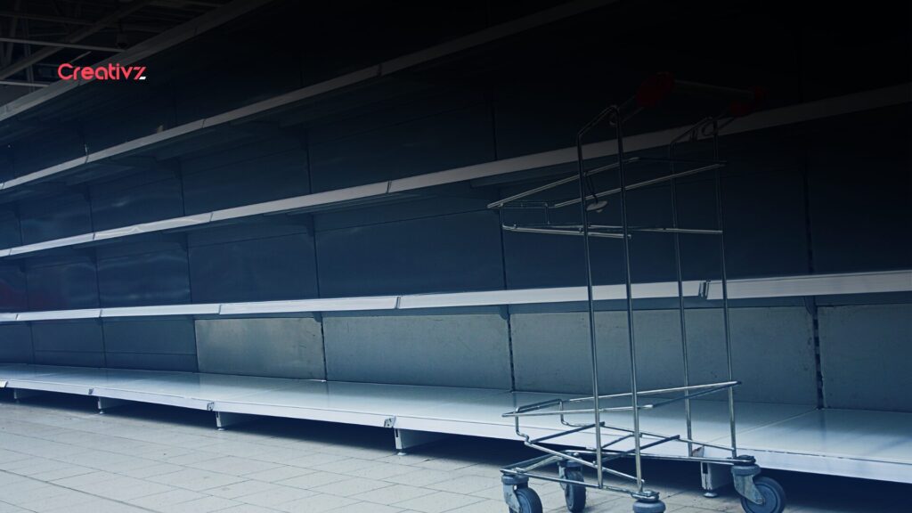 Nearly empty retail shelves inside a large department store, illustrating inventory shortages during rapid expansion.