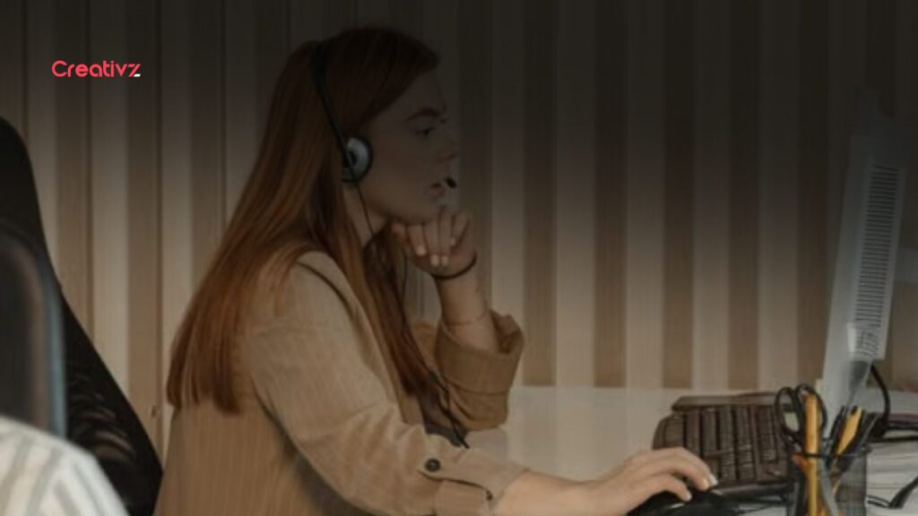 Front desk employee managing incoming calls and customer requests during a busy workday.